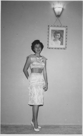 Khim standing next to her studio portrait at 16 Phuah Hin Leong Road, Penang (circa 1957 or later)